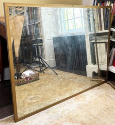 A Modern Brass Framed Mirror By Bassett