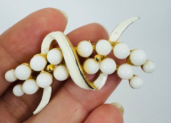 SIGNED BSK GOLD TONE WHITE ENAMEL AND WHITE STONE BROOCH
