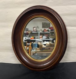Vintage Wooden Oval Mirror With A Gold Color Shade Around The Mirror. CVR/D3