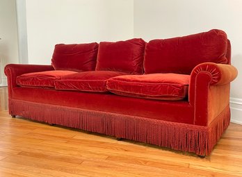 A Vintage Rolled Arm Sofa In Red Velvet With Fringe Trim