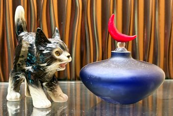 A Perfume Bottle And Cat Decor