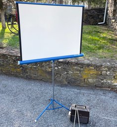 A Vintage 8MM Projector And Screen