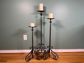 An Attractive Trio Of Floor Standing Pillar Candle Holders In Wrought Iron