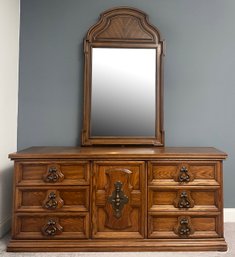 A Paneled Fruitwood Dresser With Mirror In Spanish Revival Style