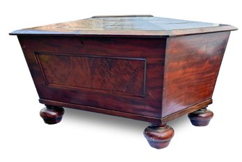 An English Regency Cellarette, Or Wine Cooler In Flame Mahogany With Castered Bun Feet