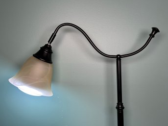 A Contemporary Adjustable-Angle Floor Lamp With A Weighted Base & Swirled Glass Shade