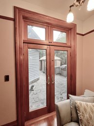 A Pair Of Andersen Double French Doors With Transom Lites And Retractable Screens