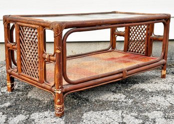 A Vintage Rattan Coffee Table With Glass Top