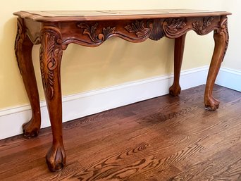 A Carved Wood Claw Foot Console With Paneled Glass Top