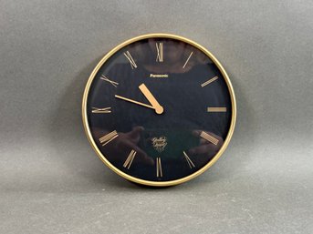 A Wall Clock By Panasonic In Black & Gold