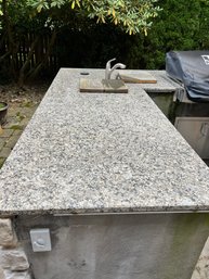 A Granite Outdoor Kitchen Counter Top With Two Built In Sinks -