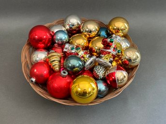 A Pretty Woven Basket Full Of Glass Christmas Ornaments