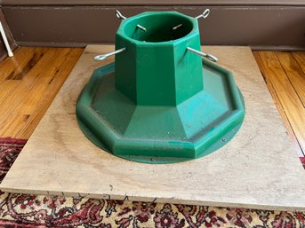 Green Plastic Christmas Tree Stand Mounted On Wooden Base