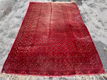 An Antique Hand Knotted And Dyed Bokhara Rug