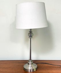 A Chrome And Glass Stick Lamp