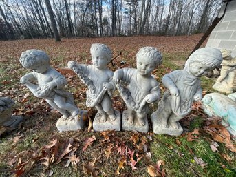 FOUR CAST STONE CHERUBS W/ FLOWERS