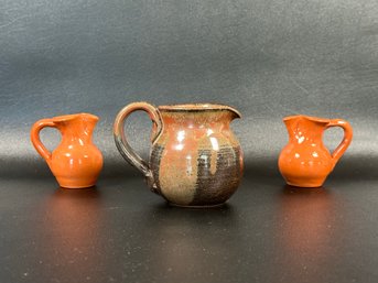 A Set Of Compatible Pottery Pitchers