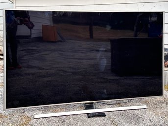 A Samsung 65' Flat Screen TV And Stand