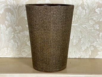 A Woven Wastebasket With Leather Lining