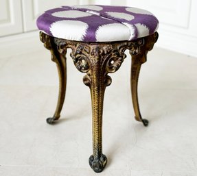 An Antique Cast Iron Stool With New Fabric Cover