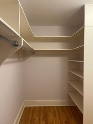 A Full Walk In Closet - Shelving And Chrome Rods