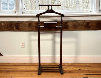 A Valet Stand In Dark Stained Wood