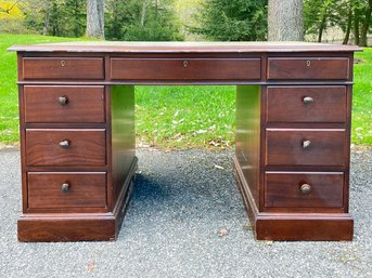 A Vintage Paneled Mahogany Leather Top Kneehole Desk