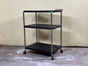 A Rolling Tiered Metal Cart In Black