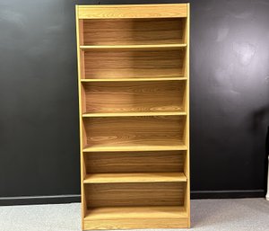 A Tall Transitional Bookcase In Oak Veneer