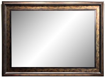 A Large Beveled Mirror In Bronze Tone Frame