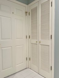 A Set Of Louvered Wood Double Doors