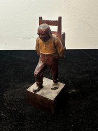 Wood Sculpture Of Colonial Man Carrying Chair