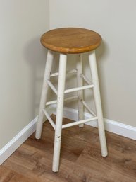 A Wooden Stool With White Painted Base
