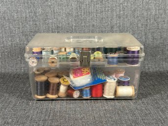 A Clear Plastic Sewing Box Full Of Thread