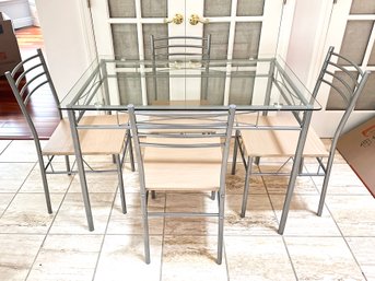 A Modern Steel And Glass Dining Table And Set Of 4 Chairs