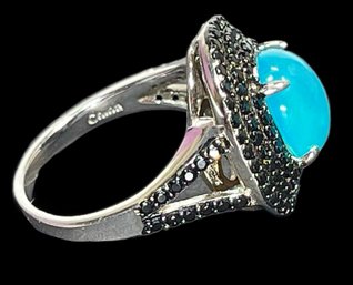 Fine Sterling Silver Ladies Ring Having Translucent Blue Stone Surrounded By Black Stones