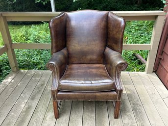 A Brown Arm Chair With Nailhead Detail