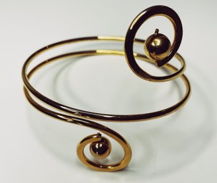 Gold Tone Bangle Style Bracelet With Swirl Design