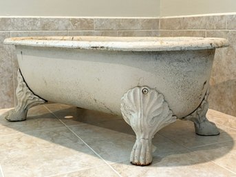 An Antique Cast Iron Claw Foot Baby Bath Tub