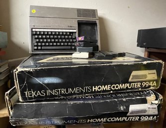 TWO TI HOME COMPUTERS IN BOX AND A TI GAME CONSOLE