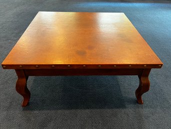 Handsome Leather Top Coffee Table With Large Grommet Detail