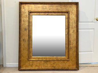 A Large Gilt Wood Framed Beveled Mirror