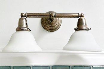 A Brushed Steel And Frosted Glass Sconce