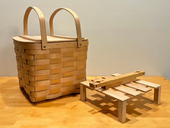 A Woven Picnic Basket And Stand