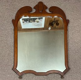 A Vintage Mirror In A Wood Frame