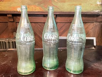 Three Vintage Coke Bottles