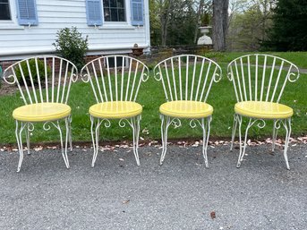 A Set Of 4 Wrought Iron And Vinyl Dining Chairs