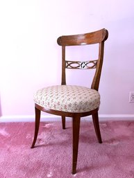 An Antique Occasional Chair With Carved Detailing And A Floral Seat