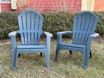 A Pair Of Adirondack Chairs In Woodgrain Plastic