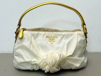 A Beautiful White And Gold Purse By Prada